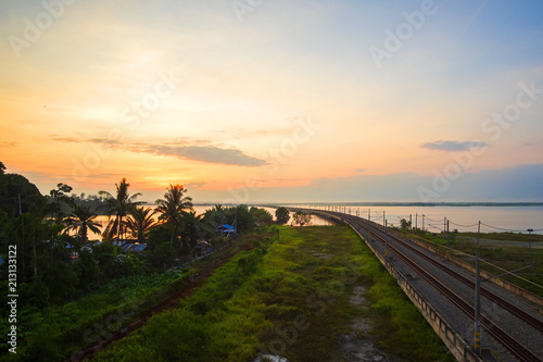 Beautiful Sunrise over Floating Railway at    Bukit Merah Malaysia    . Soft Focus Motion Blur due to Long Exposure.Visible Noise due to High ISO.