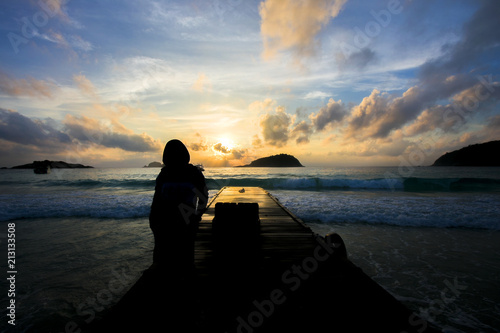 Beautiful view of Redang Island Terengganu Malaysia during Sunrise with sillhoutte of girl. Soft focus blur due to Long Exposure.Visible Noise due to High ISO.