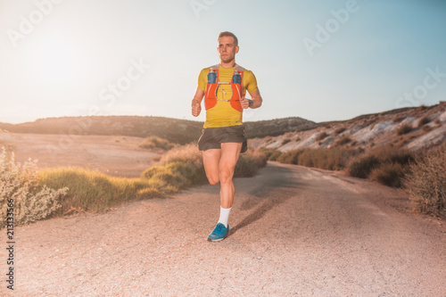 Young man running with greenish yellow shirt