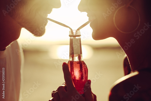 Loving couple sharing a soft drink