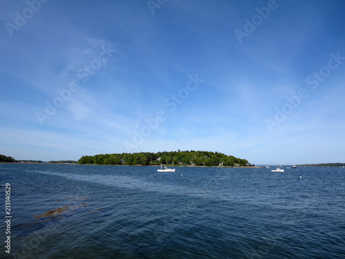 Boats in the water in front of Littlejohn Island, Yarmouth, Maine photo