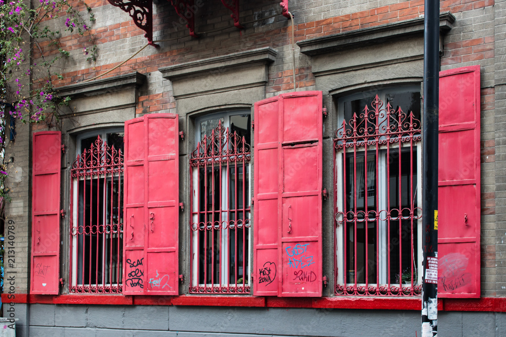 red windowed building at urban street red windowed building at urban street