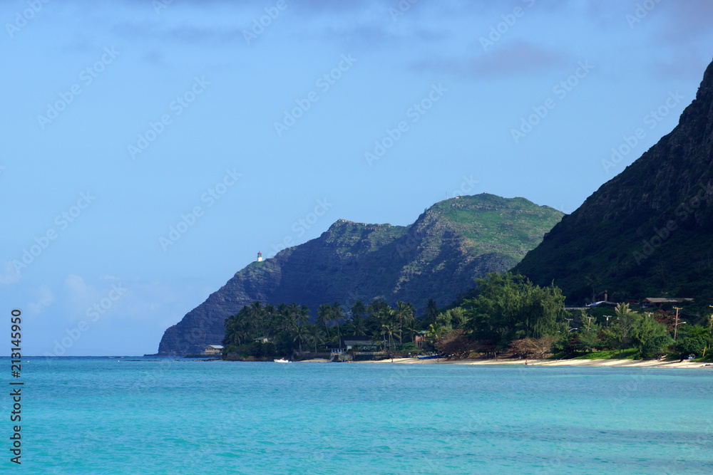 Waimanalo beach, bay, and Makapuu Point with Makapu'u Lighthouse visible on cliffside mountain Waimanalo beach, bay, and Makapuu Point with Makapu'u Lighthouse visible on cliffside mountain