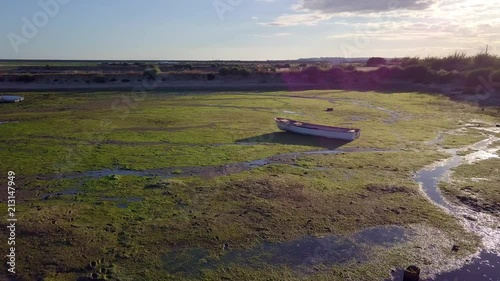 Abandoned boat on the middle of Ria formosa during low tide in Olhao, Portugal