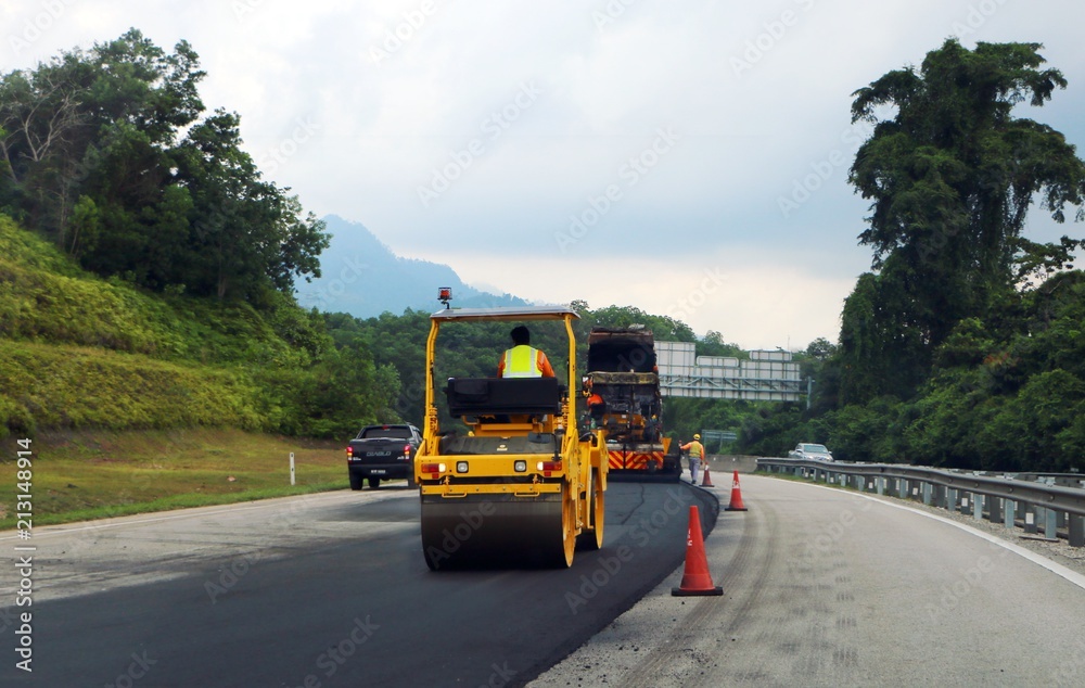 Terengganu, Malaysia - July 3, 2018: Asphalt Roller aligns new asphalt on highway road at  East Coast Expressway  or Lebuhraya Pantai Timur (LPT) in Terengganu.