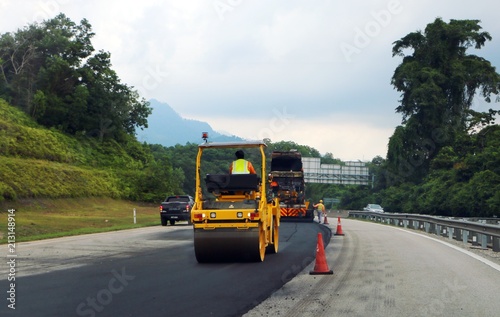 Wallpaper Mural Terengganu, Malaysia - July 3, 2018: Asphalt Roller aligns new asphalt on highway road at  East Coast Expressway  or Lebuhraya Pantai Timur (LPT) in Terengganu. Torontodigital.ca