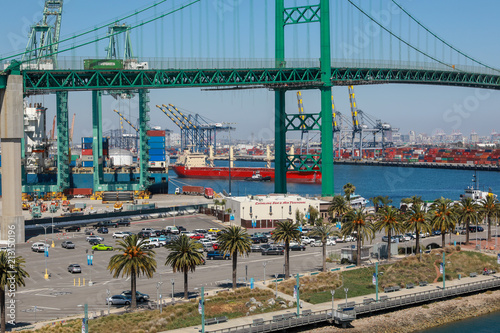 Worldwide Supply Chain Bulk Carrier Cargo Ship Entering into San Pedro Harbor and Vincent Thomas Bridge and Container Ships Unloading in Los Angeles Long Beach California Shipping Port © Jill Clardy