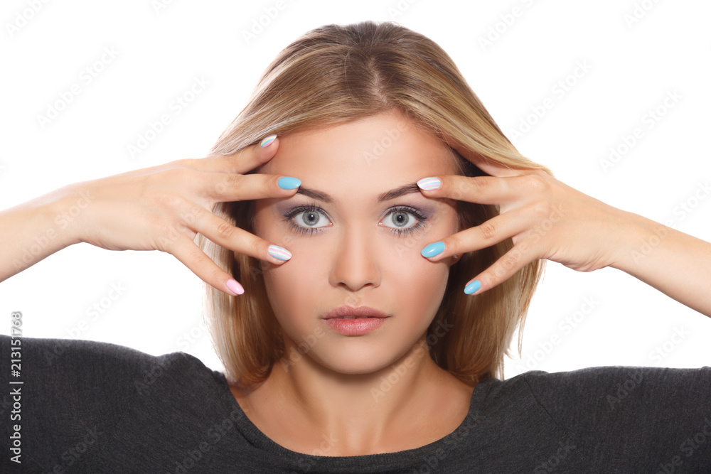 Fototapeta premium Young beautiful girl holding hands in front of face