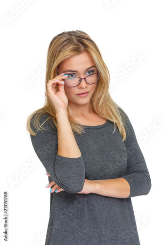 Young cute girl looking out from under her glasses