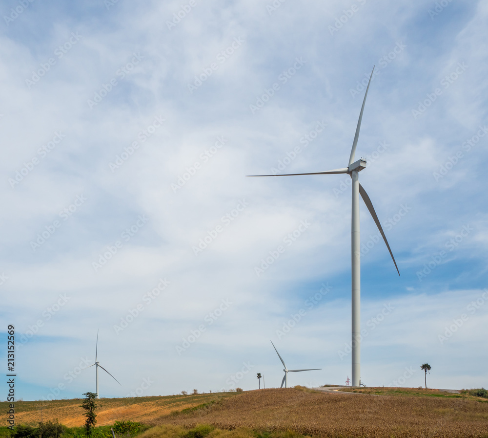 Fototapeta premium Landscape Wind turbines generating electricity with blue sky and mountain