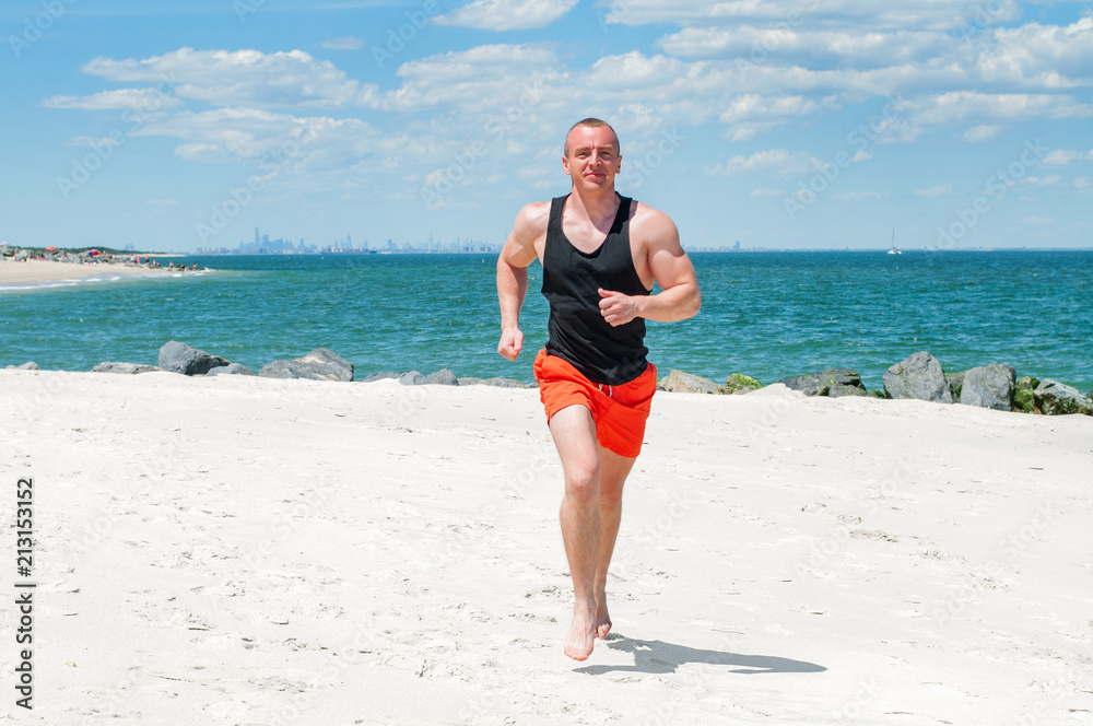 Workout. Athletic man running on beach. Workout. Athletic man running on beach.