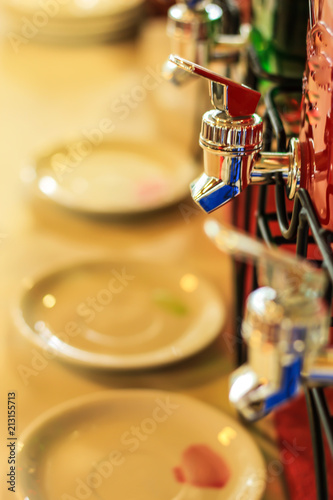 Faucet with glass jar on the table.