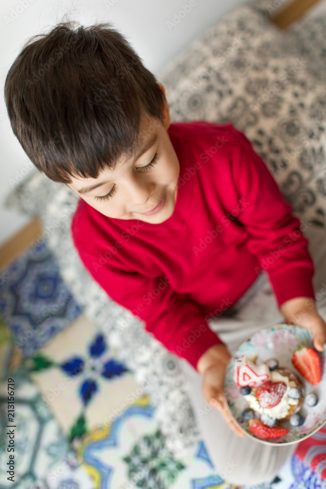 High angle view of boy holding birthday cake High angle view of boy holding birthday cake