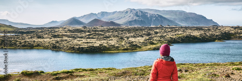 Schilderij op canvas Iceland hiking travel adventure - woman tourist walking in mountain landscape looking at amazing view of nature, panorama banner