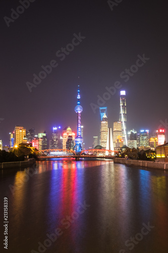 Vertical photo - Shanghai, China - December 24, 2017: Shanghai Skyline at night - long exposure - radiant reflection