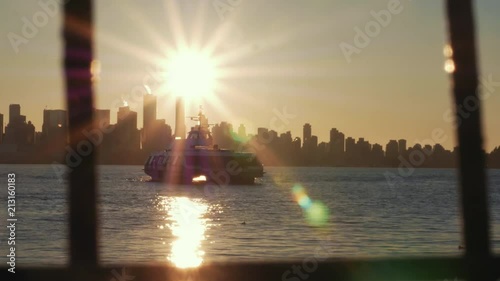Sunsetting through city skyline as friends in fishboat enjoy the harbor view photo