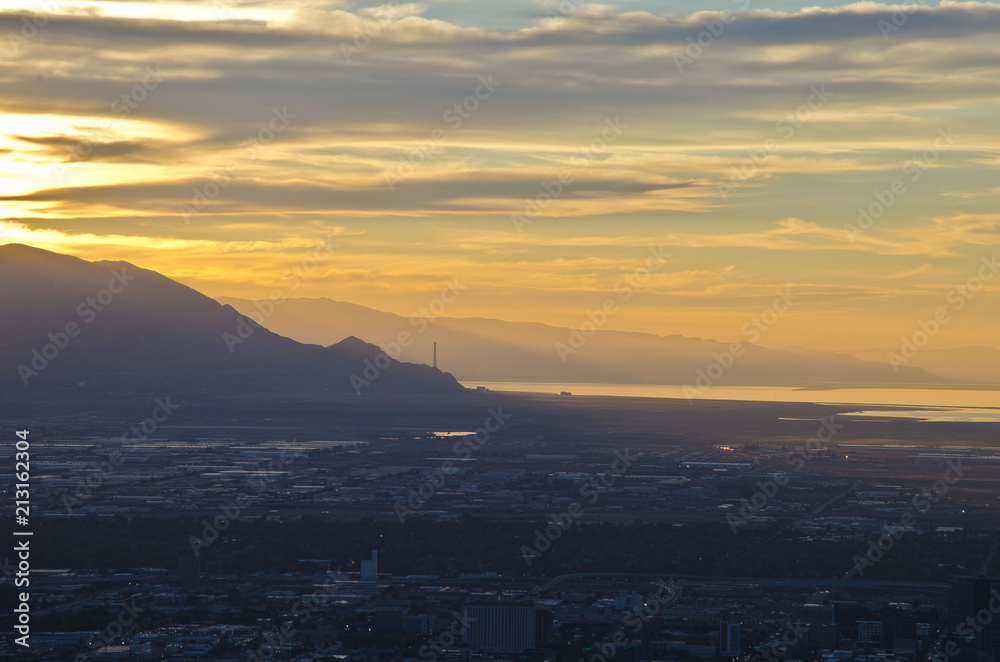 A smog sunset over the salt lake city valley in the evening summer sun. A smog sunset over the salt lake city valley in the evening summer sun.