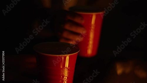 Women Celebrate Together At A Beach Bonfire, They Cheers And Drink From Red Cups