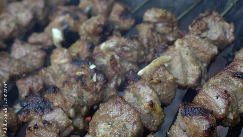 Extreme closeup of charred skewered lamb on a hot smoking grill. Extreme closeup of charred skewered lamb on a hot smoking grill.