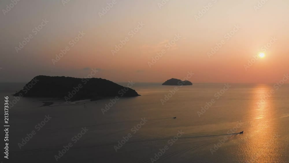 Along the sea against the backdrop of the sunset and islands. Boat in the sea at sunset Along the sea against the backdrop of the sunset and islands. Boat in the sea at sunset
