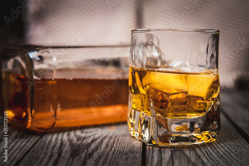 Glass and bottle of bourbon whiskey