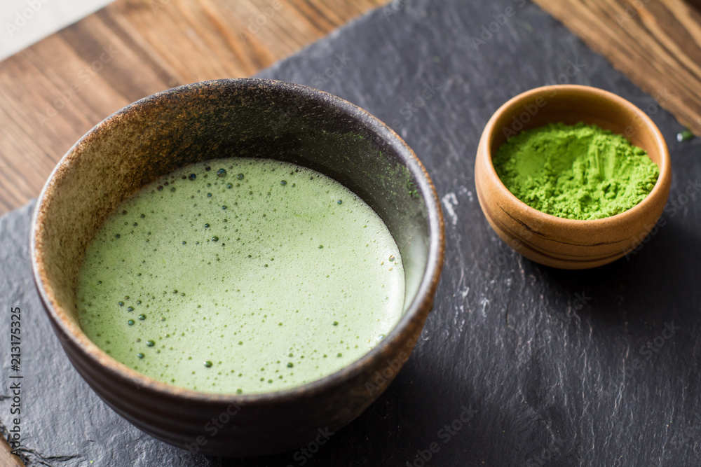 green matcha tea prepearing on stone black table green matcha tea prepearing on stone black table