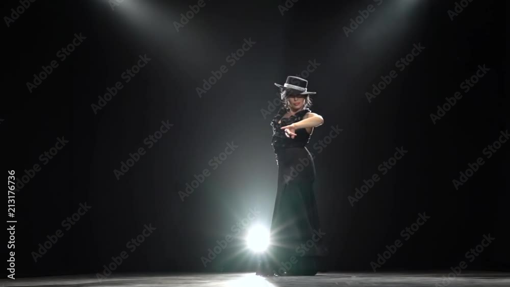 Girl dancing a Spanish incendiary dance. Black background. Llight from behind. Slow motion Girl dancing a Spanish incendiary dance. Black background. Llight from behind. Slow motion
