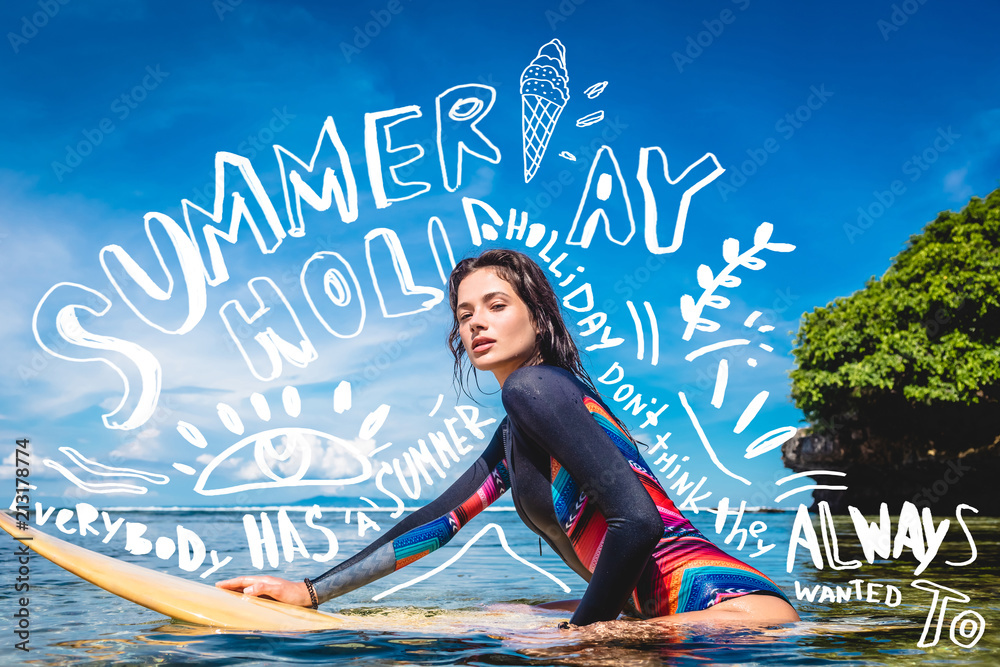 sportswoman in wetsuit on surfing board in ocean at Nusa dua Beach, Bali,  Indonesia. Lettering and drawing for Summer holiday Stock Photo | Adobe  Stock