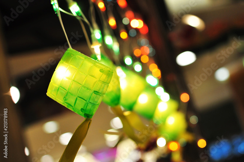 a string of colorful lighting with small bulbs in ketupat decoration, bokeh effect