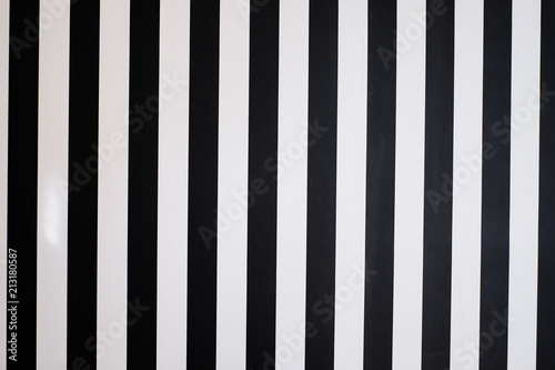 Stripe of black color on white wall background.