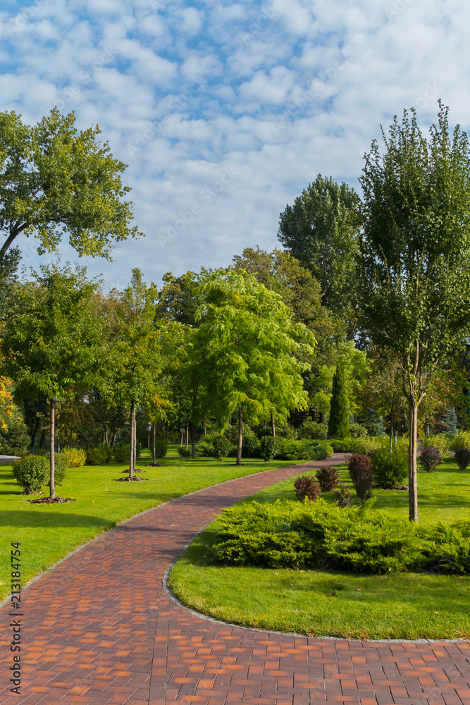 red track in a green park with beautiful trees on a summer day. Mezhyhir'ya. Ukraine red track in a green park with beautiful trees on a summer day. Mezhyhir'ya. Ukraine