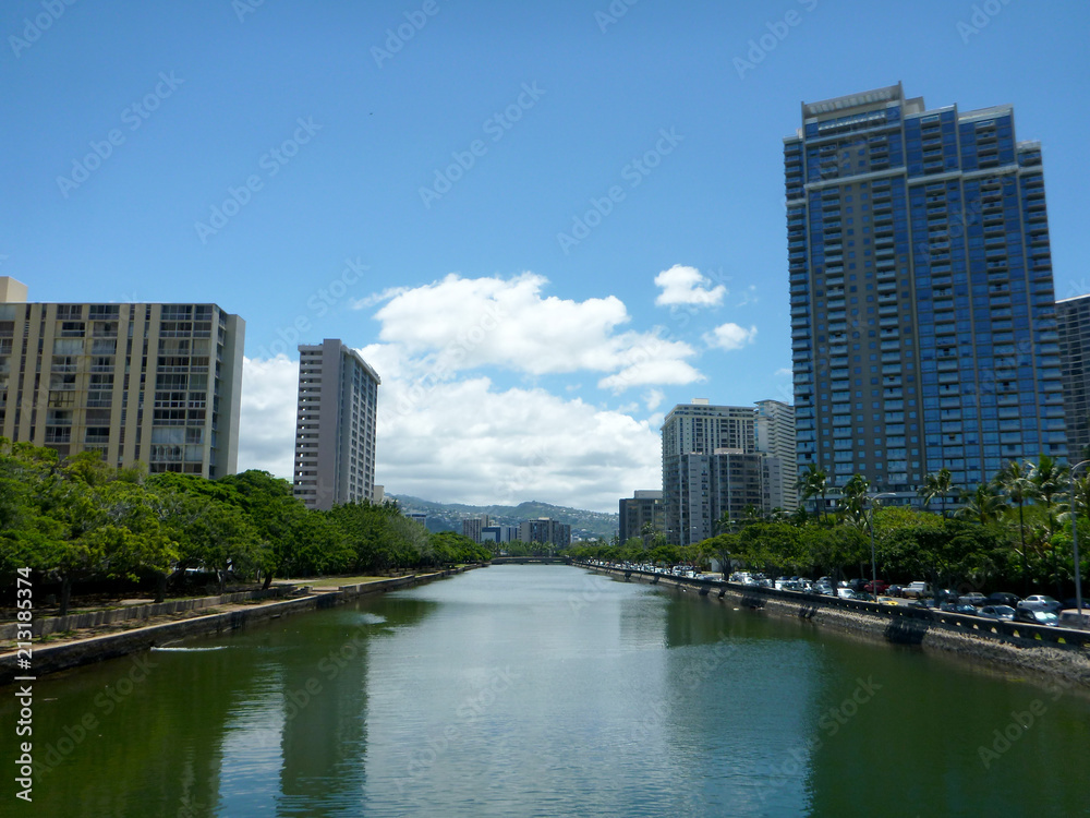 Ala Wai Canal in Waikiki surrounded by tall buildings and trees