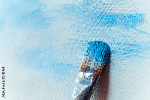 Paint brush on a painted canvas