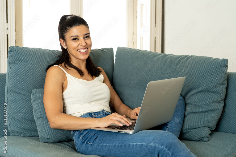 happy pretty latin woman working on laptop at home. happy pretty latin woman working on laptop at home.