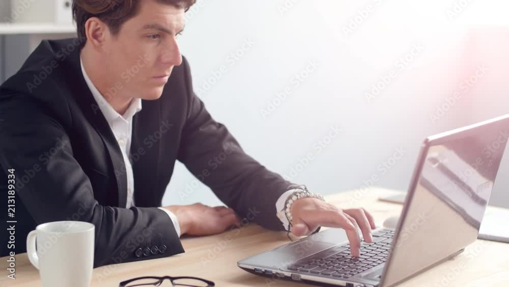 Young man working on laptop at office Young man working on laptop at office