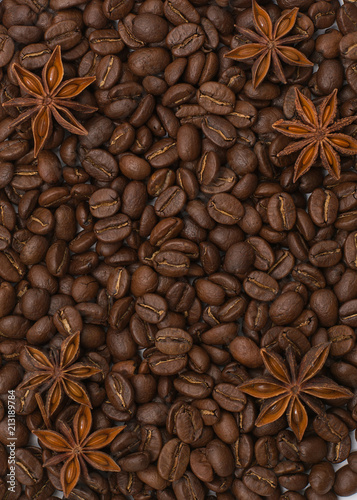 Background of coffee beans. Coffee texture. Cinnamon sticks and cardamom.