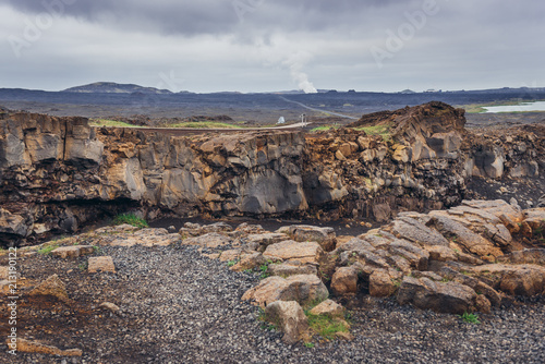 Rocks next to symbolic footbridge between two continents in Reykjanes Peninsula in Iceland photo