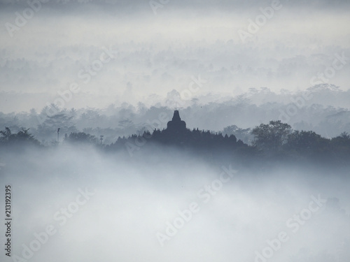 Borobudur Temple in a beautiful foggy sunrise seen from Punthuk Setumbu Hill