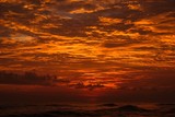 the last hour on the first day - red, orange colored cloudy sunset over the Indian ocean