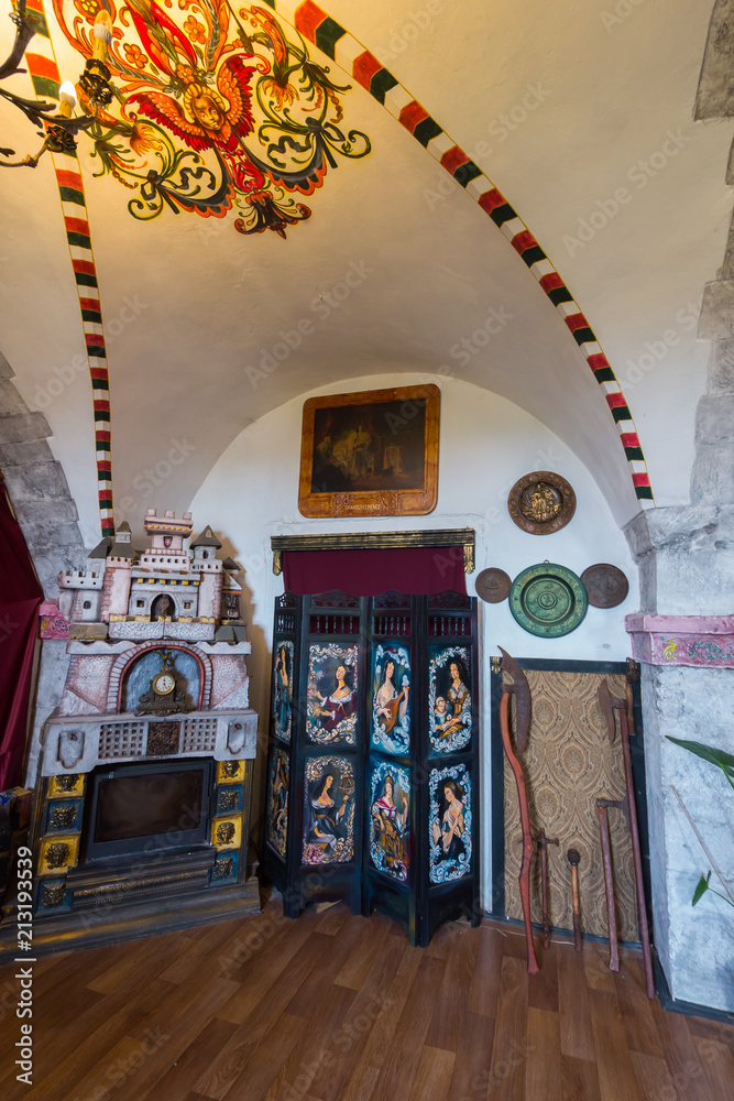 Fototapeta premium A room with a fireplace and ceiling paintings in the Mukachevo Palanok castle. Mukachevo Ukraine