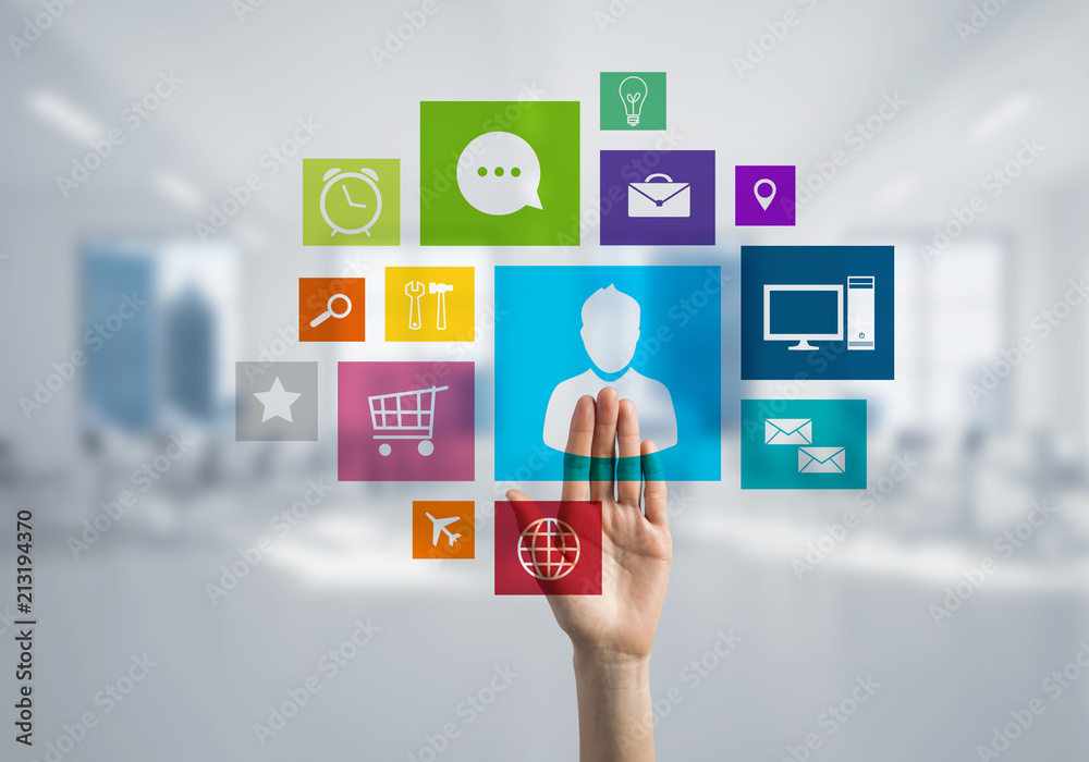 Modern office interior and close of businesswoman hand choosing icon on multimedia interface Modern office interior and close of businesswoman hand choosing icon on multimedia interface