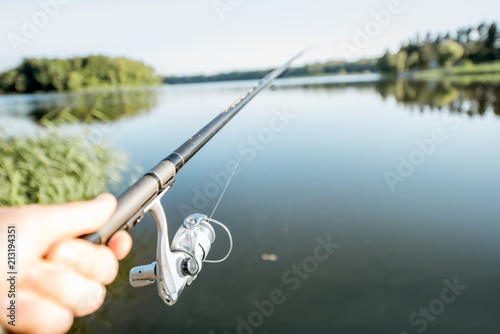 Fishing rod on the beautiful lake background during the morning light