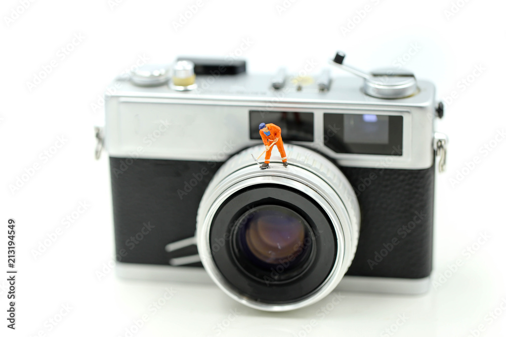 Miniature people : worker with film camera.