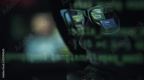 Hacker with glasses connecting online and stealing data