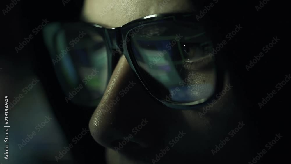 Hacker with glasses connecting online and stealing data