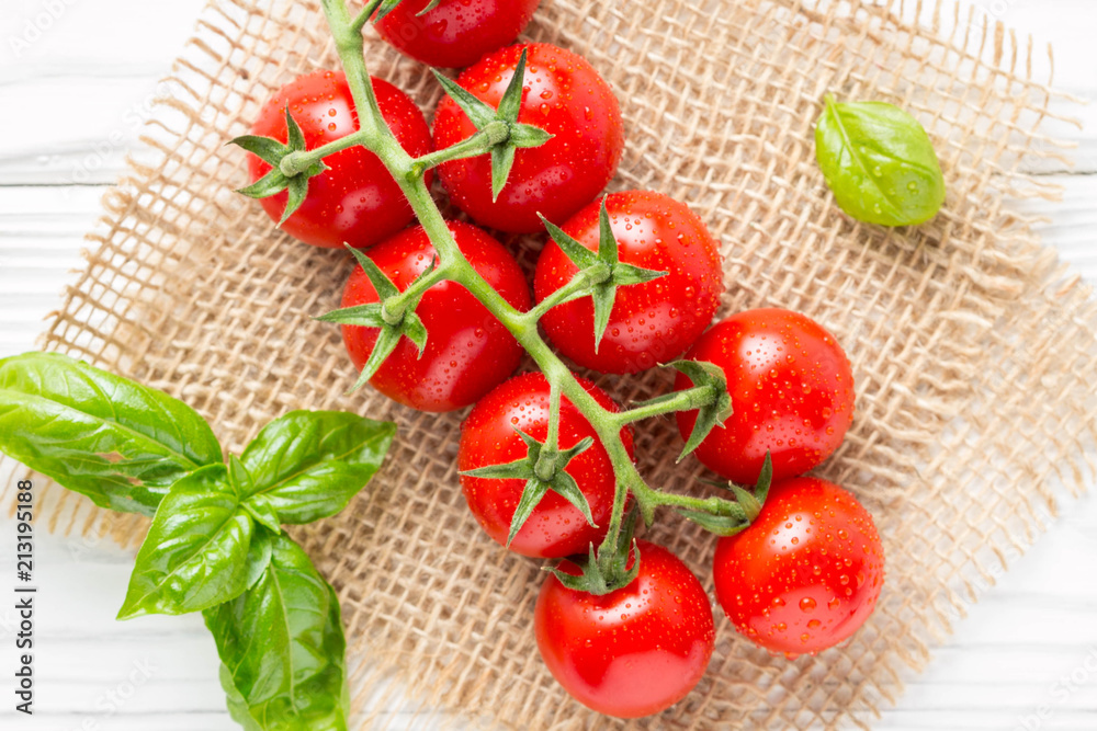 Cherry tomatoes on a branch with drops of water, macro, close up, delicious fresh harvest. Organic food