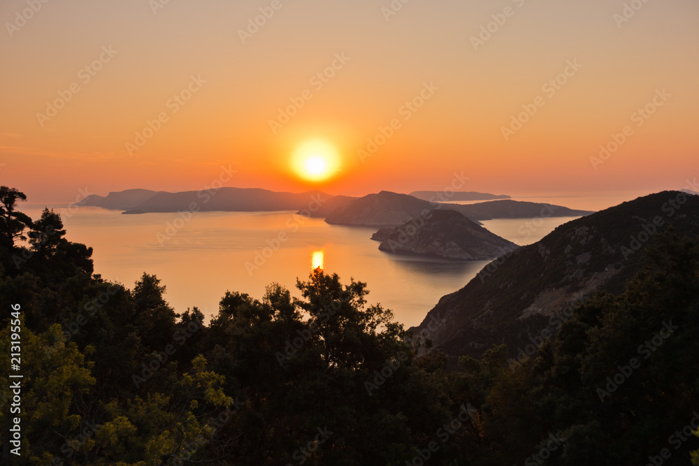 Aerial sunrise behind Alonisos island from the top of a hill in Skopelos, Greece