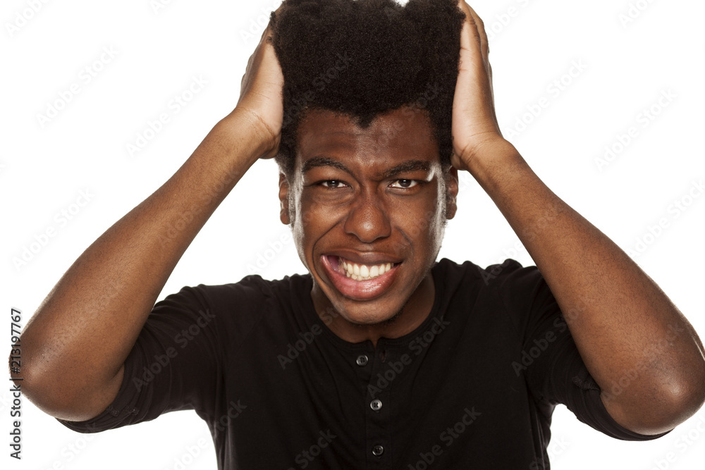 Portrait of young african american man with headache on white background Portrait of young african american man with headache on white background