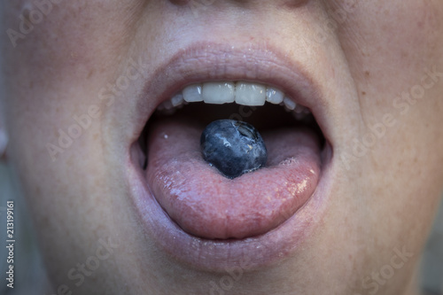 A Woman with a Blueberry in her Mouth photo