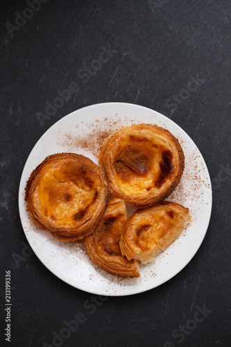 typical portuguese egg tart pastel de nata with cinnamon